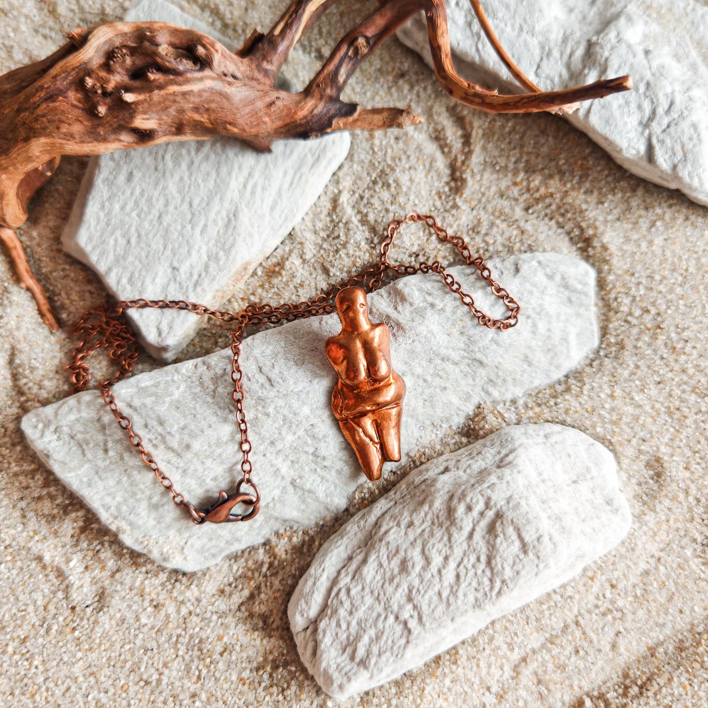 Copper necklace with a pendant Venus from Dolni Vestonice on a stone surface